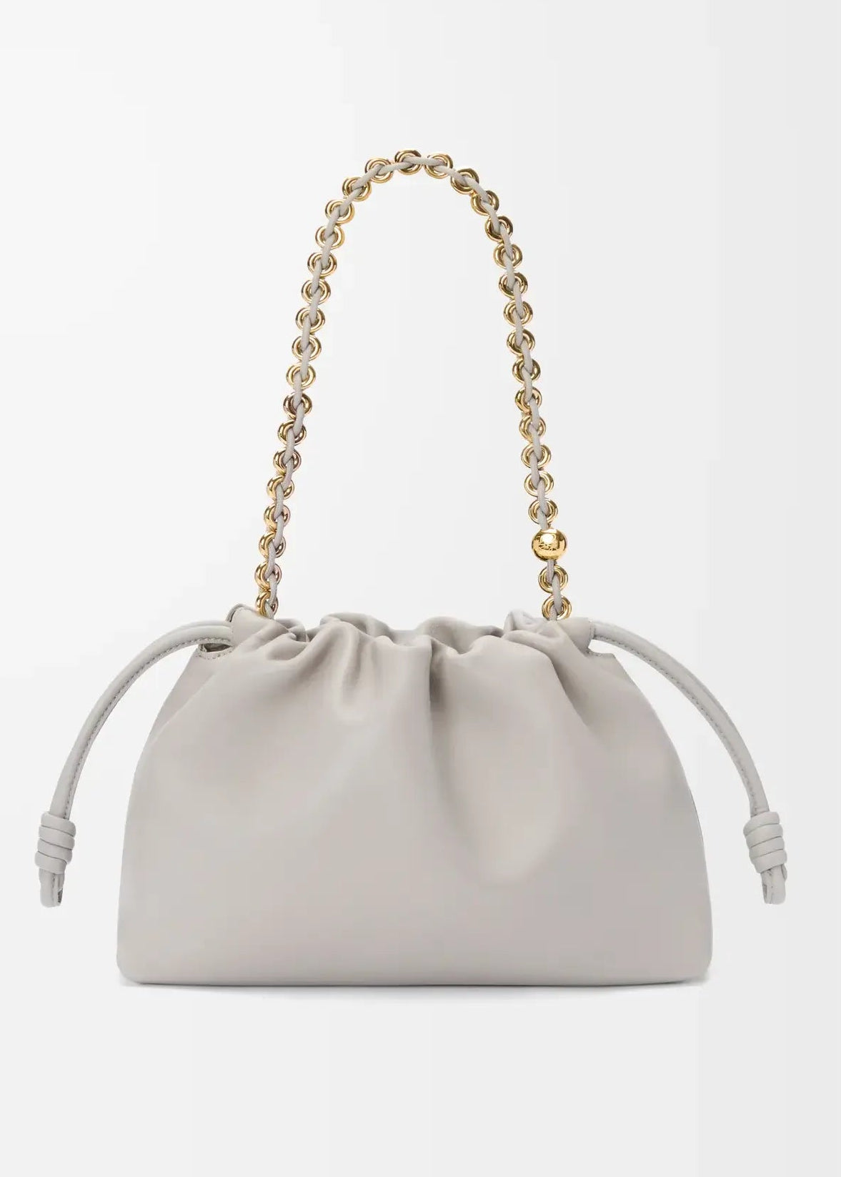 Light gray handbag with a chain handle on a light gray background