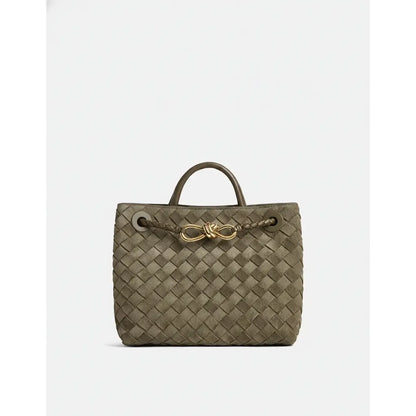 Woven handbag with a gold clasp on a white background