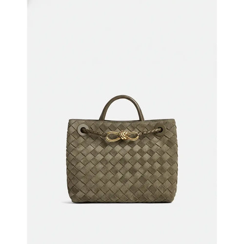 Woven handbag with a gold clasp on a white background