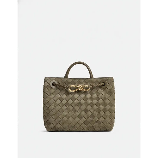 Woven handbag with a gold clasp on a white background