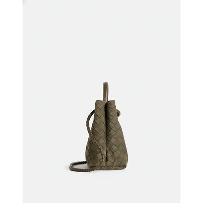 Woven green handbag on a white background
