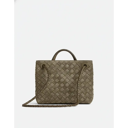 Woven handbag with a shoulder strap on a white background