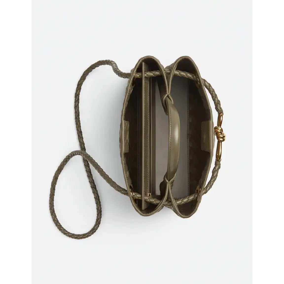 Brown leather handbag with a rope strap on a white background