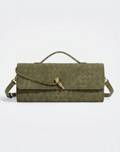 Green handbag with a gold clasp on a light gray background