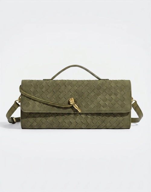 Green handbag with a gold clasp on a light gray background