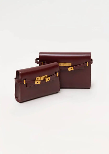 Two brown leather handbags with gold hardware on a white background